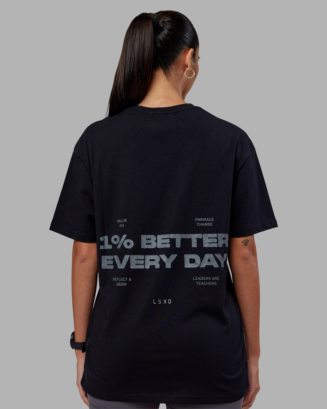 Woman wearing 1% Better Value Series FLXCotton Tee Oversize - Black-Black | Model:Rhiley | Size:XS