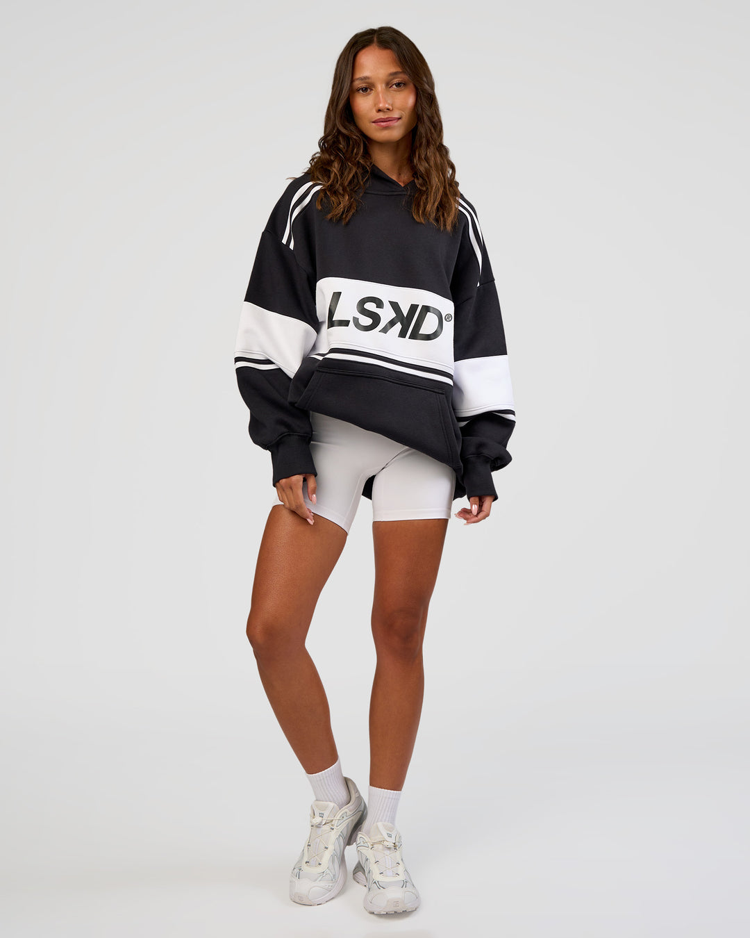 Woman wearing A-Team Oversized Hoodie - Caviar-White | Model:Dakota | Size:XS
