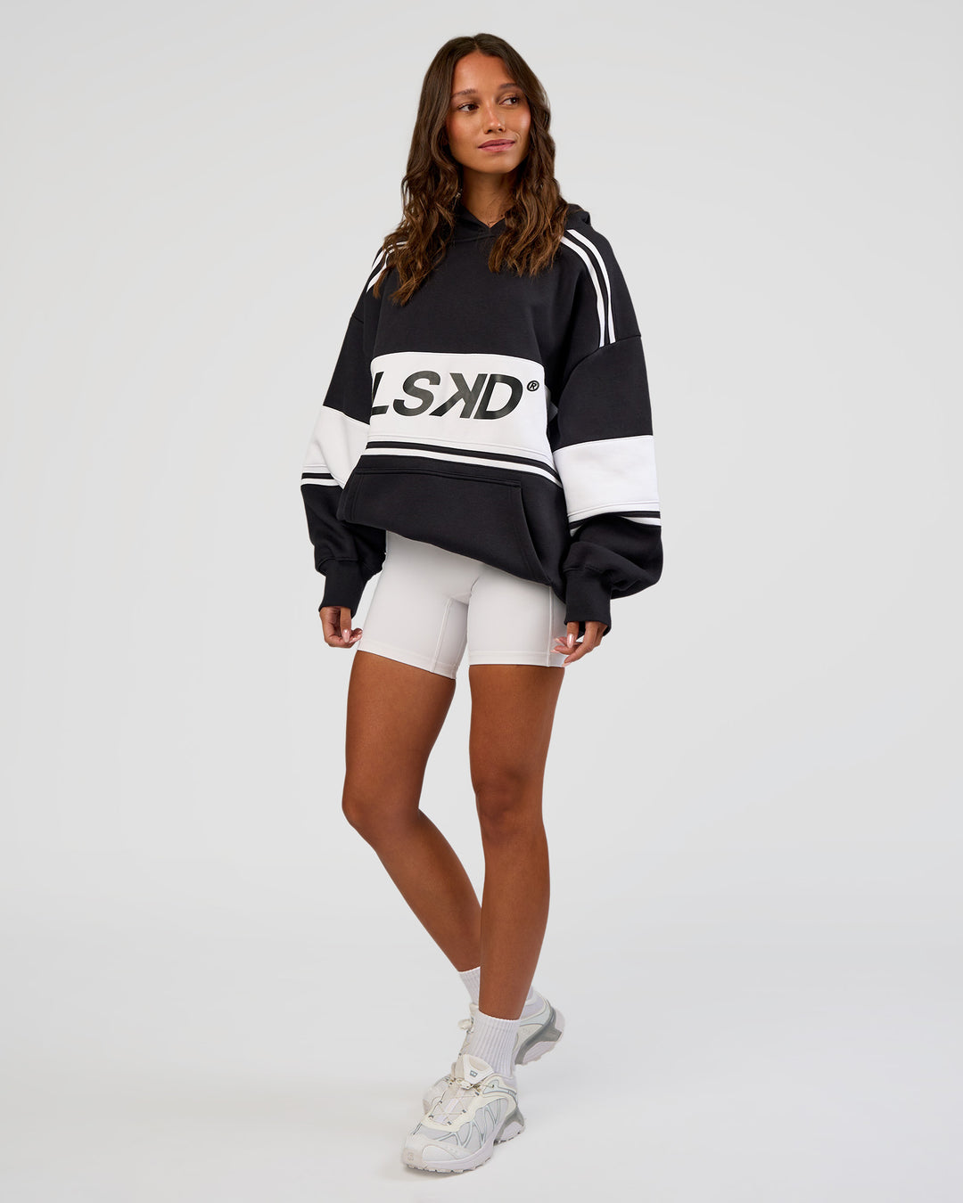 Woman wearing A-Team Oversized Hoodie - Caviar-White | Model:Dakota | Size:XS