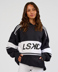 Woman wearing A-Team Oversized Hoodie - Caviar-White | Model:Dakota | Size:XS