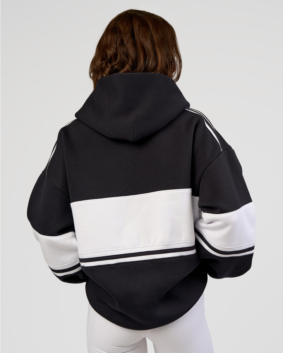 Woman wearing A-Team Oversized Hoodie - Caviar-White | Model:Dakota | Size:XS