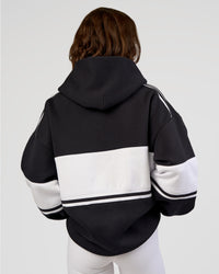 Woman wearing A-Team Oversized Hoodie - Caviar-White | Model:Dakota | Size:XS
