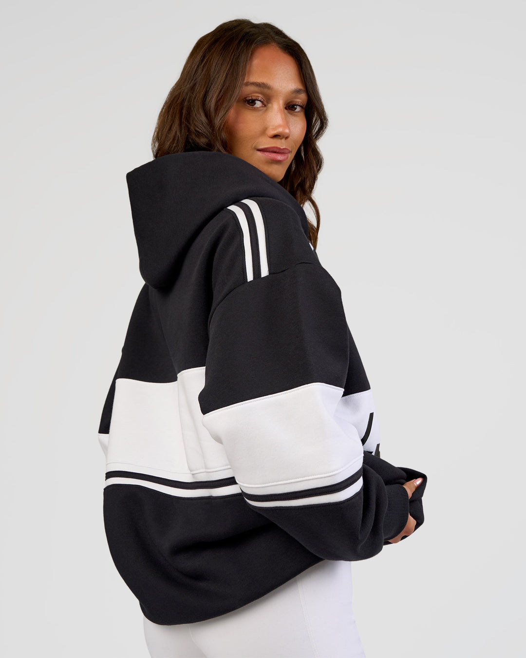 Woman wearing A-Team Oversized Hoodie - Caviar-White | Model:Dakota | Size:XS
