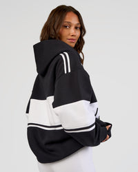 Woman wearing A-Team Oversized Hoodie - Caviar-White | Model:Dakota | Size:XS