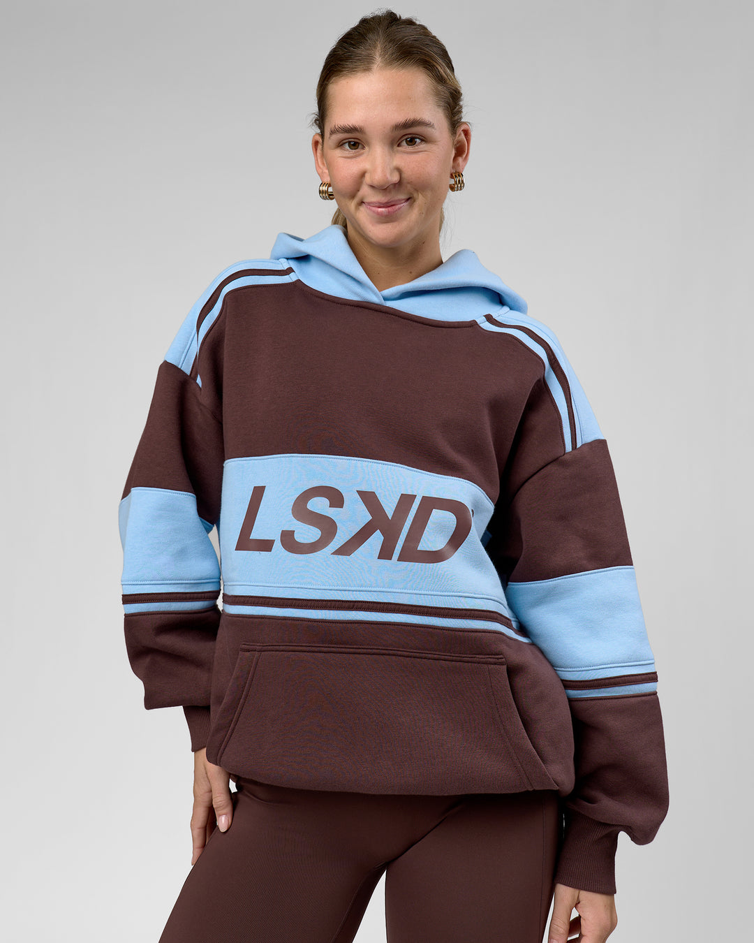 Woman wearing A-Team Oversized Hoodie - Hot Chocolate-Open Air | Model:Amity | Size:XS