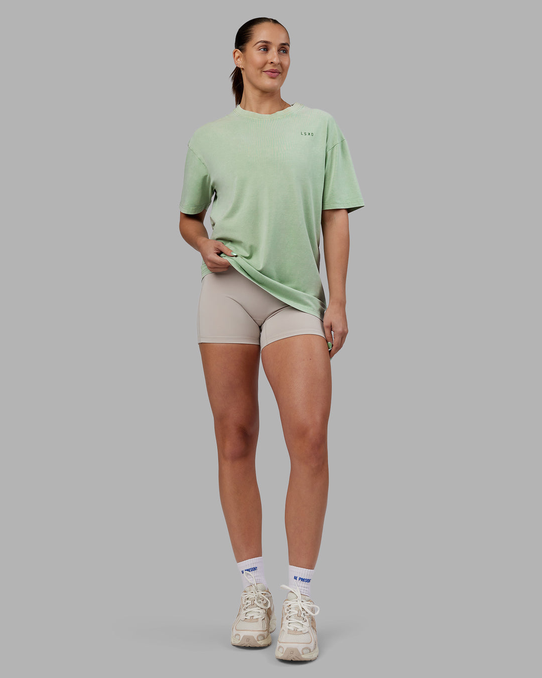 Woman wearing Abs Unisex Growth FLXCotton Oversized Tee - Matcha Green Washed | Model:Abbey | Size:XS