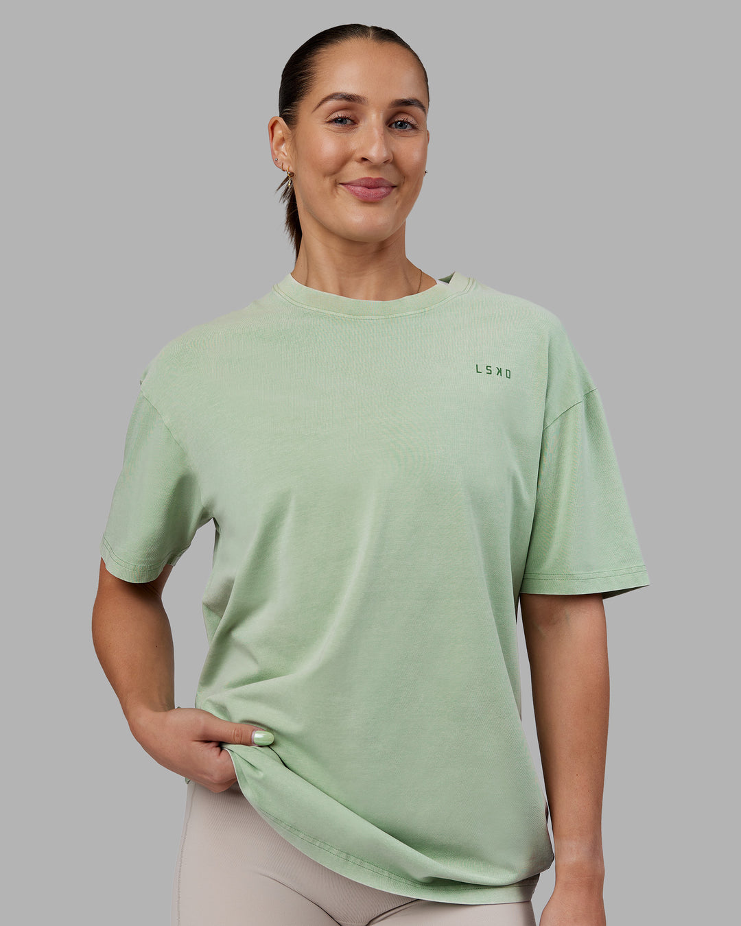Woman wearing Abs Unisex Growth FLXCotton Oversized Tee - Matcha Green Washed | Model:Abbey | Size:XS