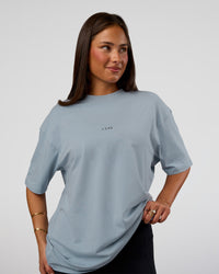 Woman wearing Abstract Haze FLXCotton Tee - Dusty Blue-Black | Model:Bianca | Size:XS
