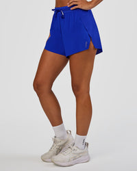 Woman wearing Accelerate 3" High-Rise Running Short - Electric Indigo | Set:true | Angle:side | Model:Brylee | Size:XS