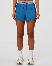 Woman wearing Accelerate 3" High-Rise Running Short - Electric Indigo-Multi | Set:true | Angle:front | Model:Brylee | Size:XS
