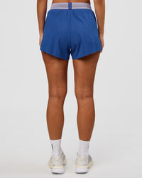Woman wearing Accelerate 3" High-Rise Running Short - Electric Indigo-Multi | Set:true | Angle:back | Model:Brylee | Size:XS