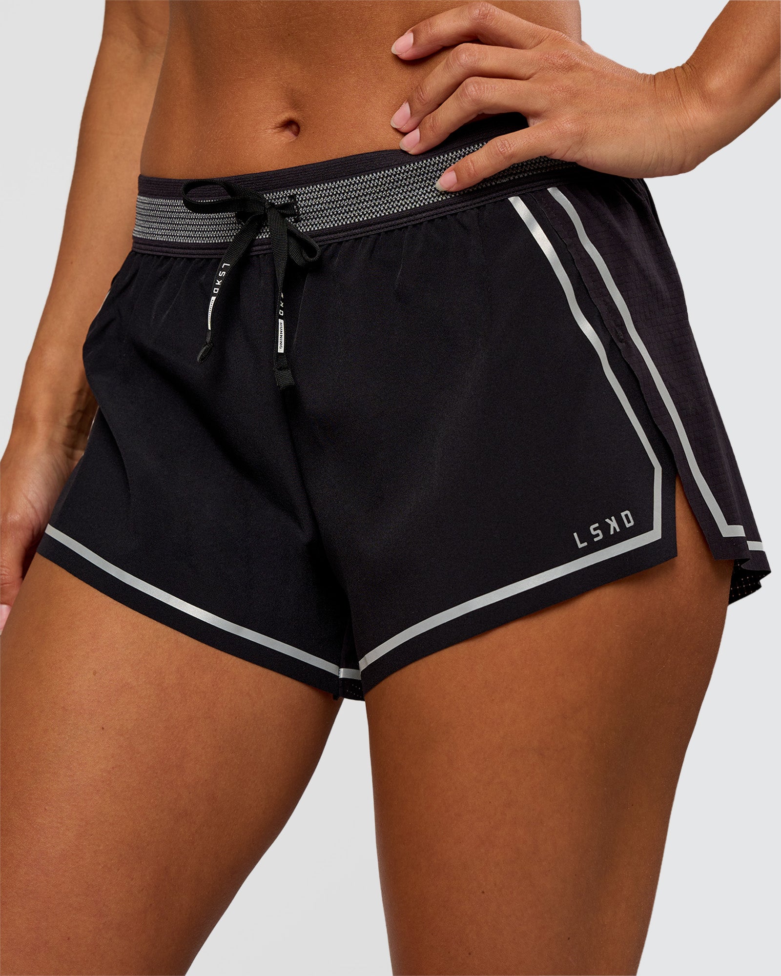 Woman wearing Accelerate 3" Reflective Mid-Rise Running Short - Black-Reflective | Set:true | Angle:closeup | Model:Brylee | Size:XS