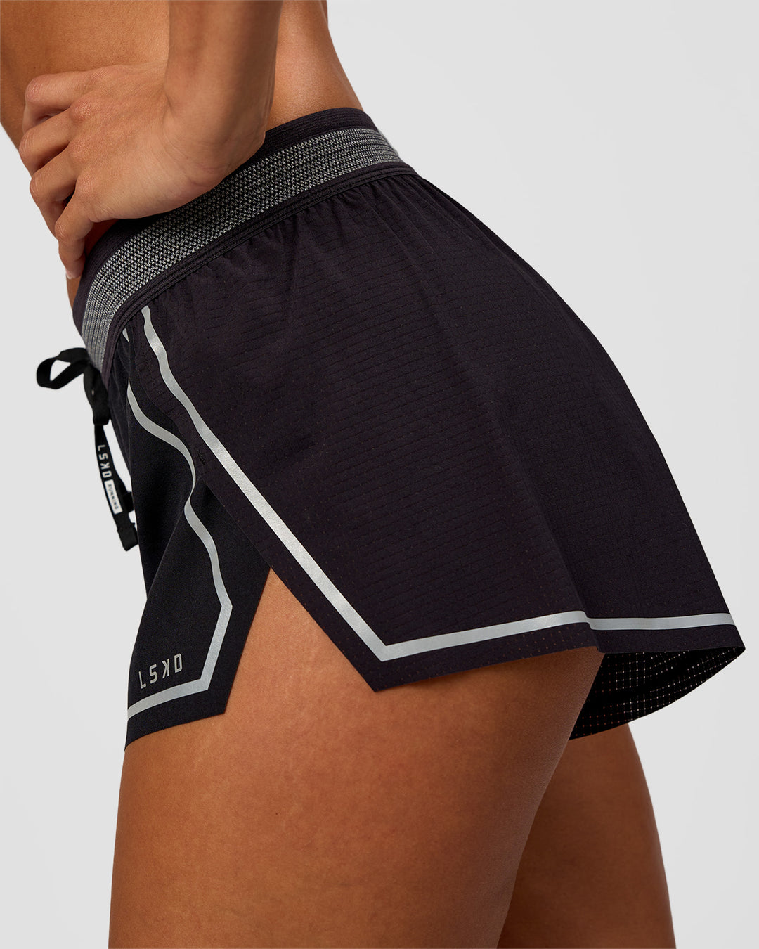 Woman wearing Accelerate 3" Reflective Mid-Rise Running Short - Black-Reflective | Model:Brylee | Size:XS