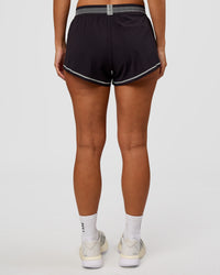 Woman wearing Accelerate 3" Reflective Mid-Rise Running Short - Black-Reflective | Set:true | Angle:back | Model:Brylee | Size:XS