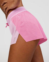 Woman wearing Accelerate 3" Mid-Rise Running Short - Candy Pink-Marshmallow | Set:true | Angle:closeup | Model:Brylee | Size:XS