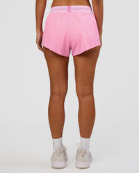 Woman wearing Accelerate 3" Mid-Rise Running Short - Candy Pink-Marshmallow | Set:true | Angle:back | Model:Brylee | Size:XS