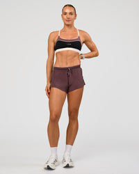 Woman wearing Accelerate 3" Mid-Rise Running Short - Cocoa Powder | Model:Maja | Size:XS