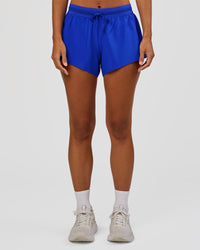 Woman wearing Accelerate 3" Mid-Rise Running Short - Electric Indigo | Set:true | Angle:front | Model:Brylee | Size:XS