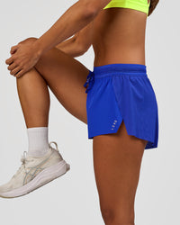 Woman wearing Accelerate 3" Mid-Rise Running Short - Electric Indigo | Model:Brylee | Size:XS