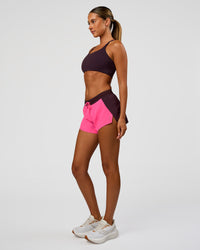 Woman wearing Accelerate 3" Mid-Rise Running Short - Midnight Plum-Sugar Plum| Model:Charli | Size:XS