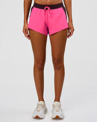 Woman wearing Accelerate 3" Mid-Rise Running Short - Midnight Plum-Sugar Plum | Set:True | Angle:front | Model:Charli | Size:XS