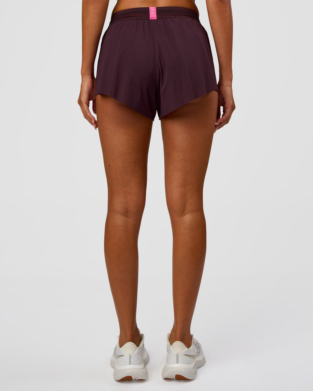 Woman wearing Accelerate 3" Mid-Rise Running Short - Midnight Plum-Sugar Plum | Set:True | Angle:back | Model:Charli | Size:XS