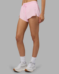 Woman wearing Accelerate 3" Running Short - Marshmallow-Candy Pink | Set:true | Angle:side | Model:Leilani | Size:XS