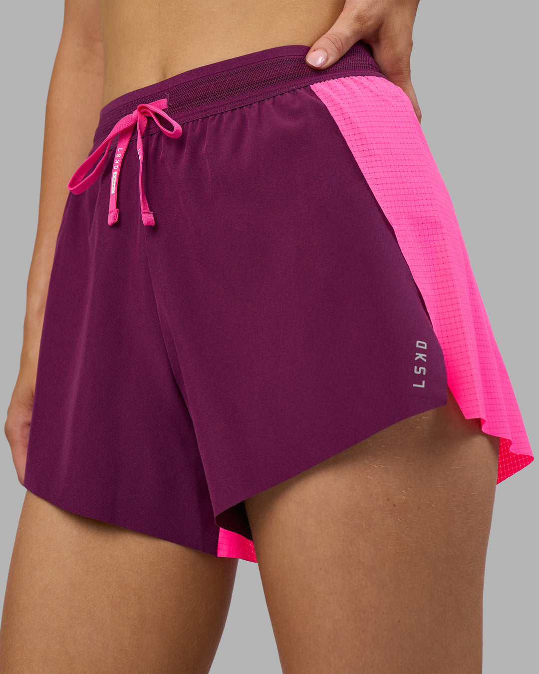 Woman wearing Accelerate 3" High-Rise Running Short - Ultra Pink-Plum Caspia | Set:true | Angle:closeup | Model:Leilani | Size:XS
