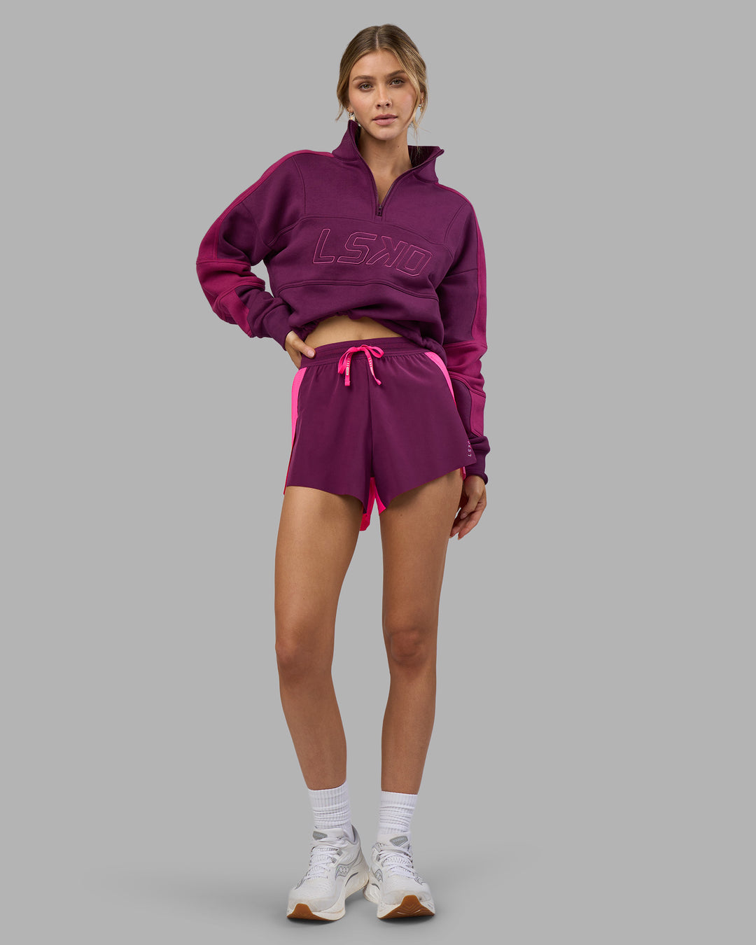Woman wearing Accelerate 3" High-Rise Running Short - Ultra Pink-Plum Caspia | Model:Leilani | Size:XS