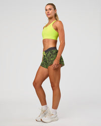 Woman wearing Accelerate Split Strap Sports Bra - Hyper Green | Model:Emelia | Size:XS