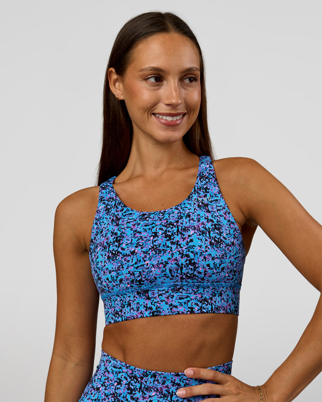 Woman wearing Accelerate Sports Bra in Energy Print Blue Multi | Model:Brylee | Size:XS