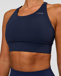 Woman wearing Accelerate Sports Bra - Future Navy | Model:Charlie | Size:XS
