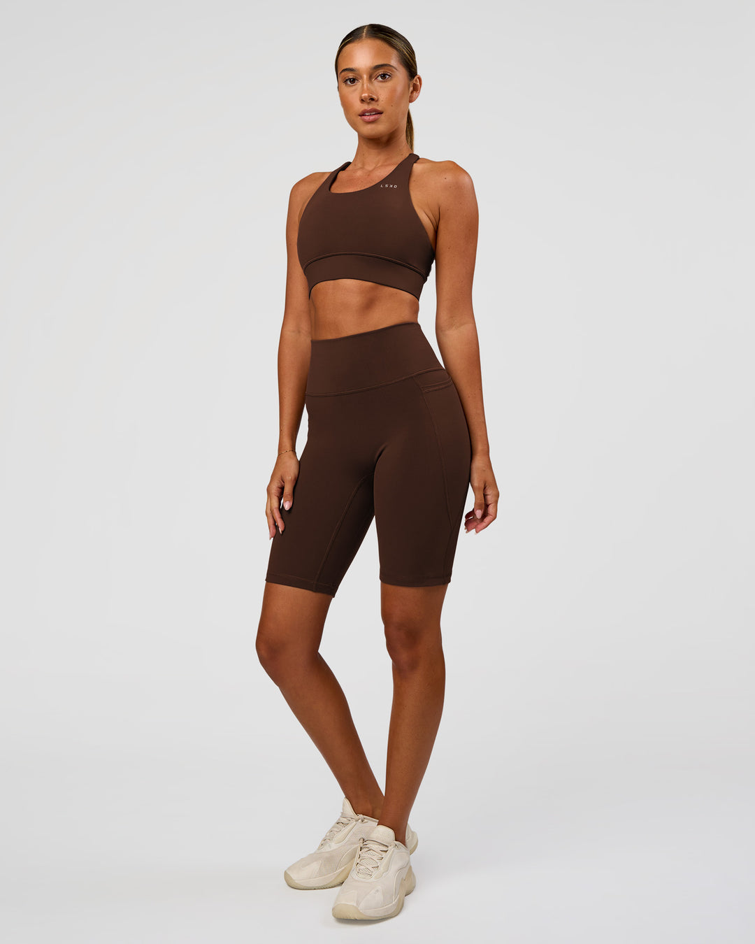 Woman wearing Accelerate Sports Bra - Hot Chocolate | Model:Charli | Size:XS