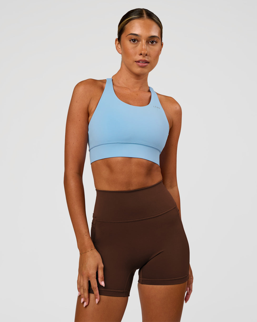 Woman wearing Accelerate Sports Bra - Open Air | Model:Charli | Size:XS