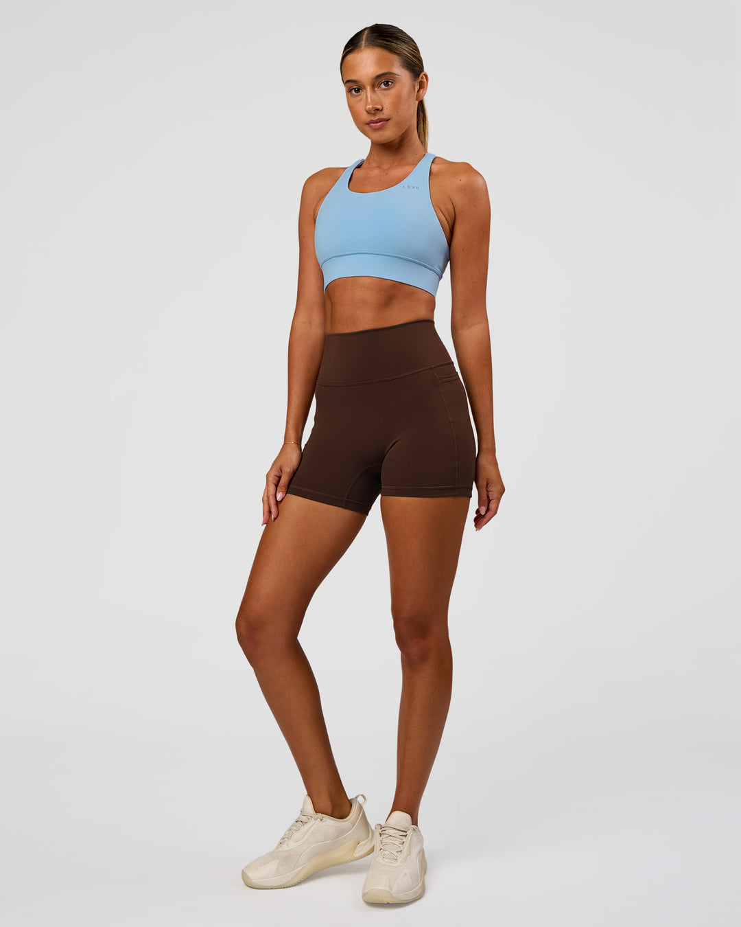 Woman wearing Accelerate Sports Bra - Open Air | Model:Charli | Size:XS