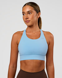 Woman wearing Accelerate Sports Bra - Open Air | Set:true | Angle:front | Model:Charli | Size:XS