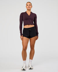 Woman wearing AeroFLX+ Long Sleeve Skimmer Half Zip - Midnight Plum/Midnight Plum | Model:Maja | Size:XS