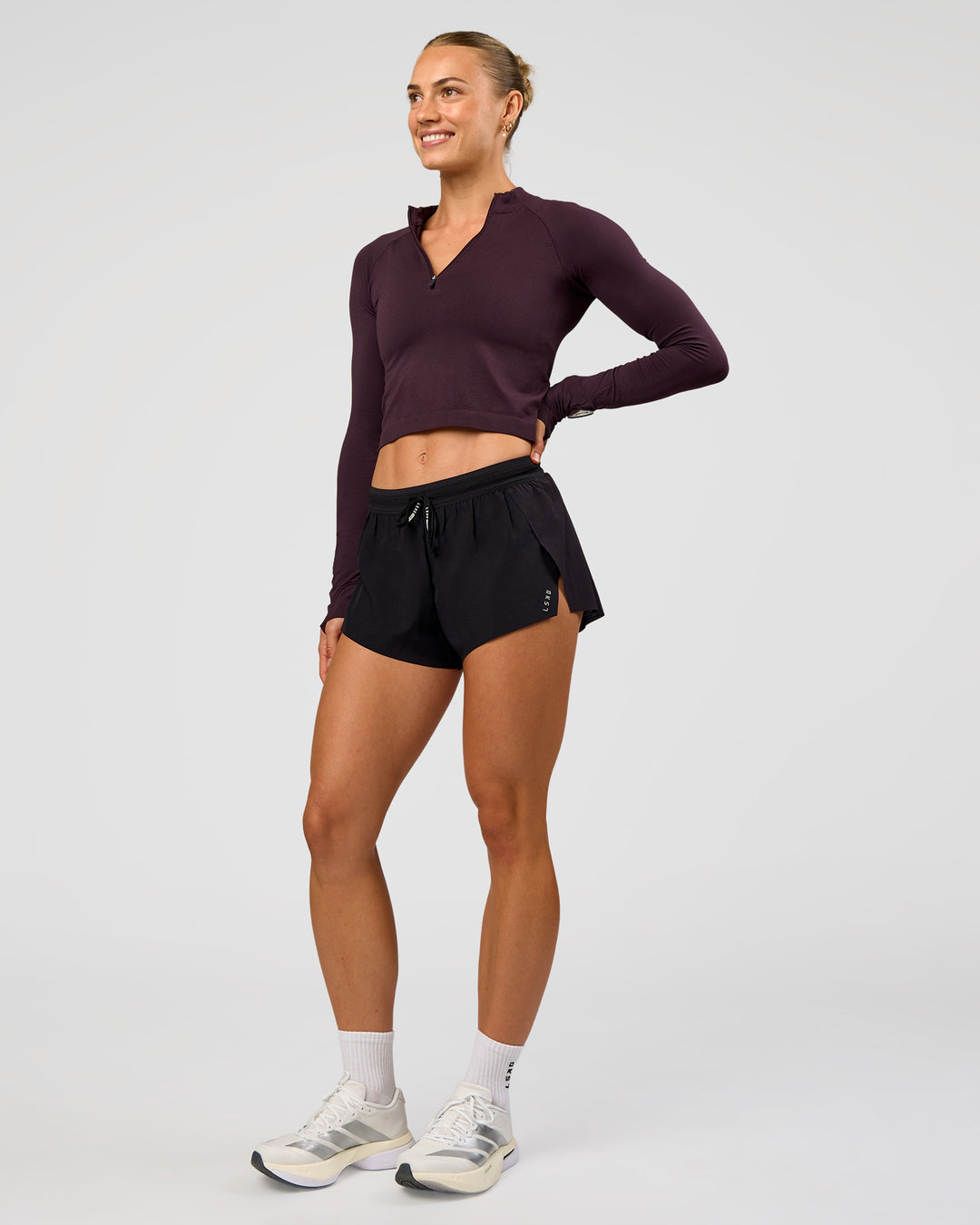 Woman wearing AeroFLX+ Long Sleeve Skimmer Half Zip - Midnight Plum/Midnight Plum | Model:Maja | Size:XS