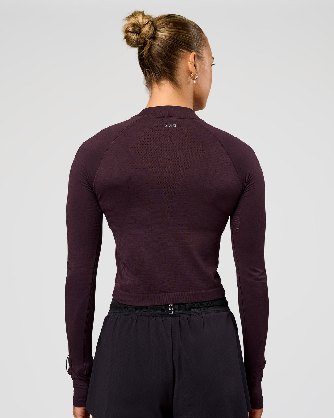 Woman wearing AeroFLX+ Long Sleeve Skimmer Half Zip - Midnight Plum/Midnight Plum | Model:Maja | Size:XS