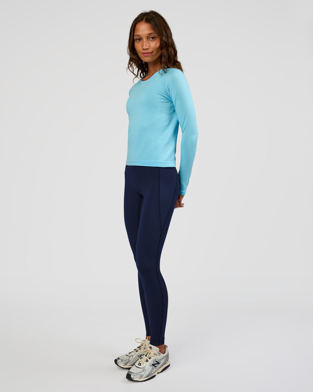 Woman wearing AeroFLX+ Seamless Long Sleeve Tee - Baltic Sea/Baltic Sea | Model:Dakota | Size:XS