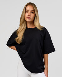 Woman wearing AfterDark ZeroCrease Boxy Tee in Black | Model:Issy | Size:XS