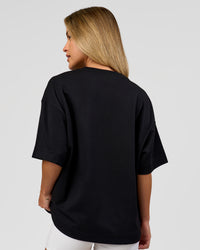 Woman wearing AfterDark ZeroCrease Boxy Tee in Black | Model:Issy | Size:XS