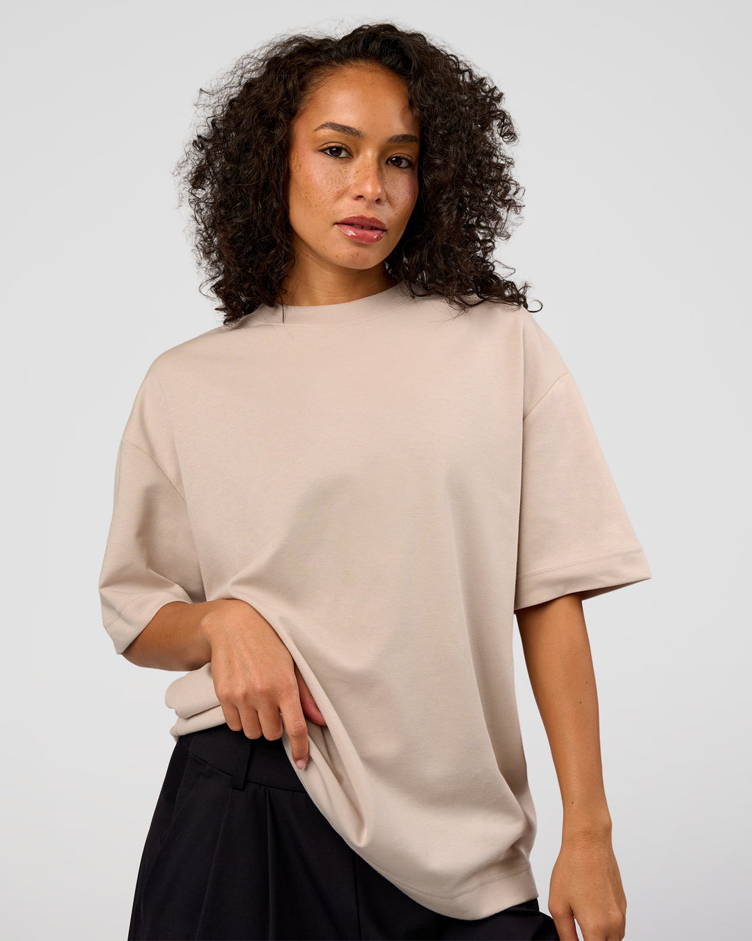 Woman wearing AfterDark ZeroCrease Oversized Tee - Shale Beige | Model:Jasmine | Size:XS