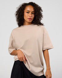 Woman wearing AfterDark ZeroCrease Oversized Tee - Shale Beige | Model:Jasmine | Size:XS
