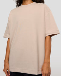 Woman wearing AfterDark ZeroCrease Oversized Tee - Shale Beige | Model:Jasmine | Size:XS