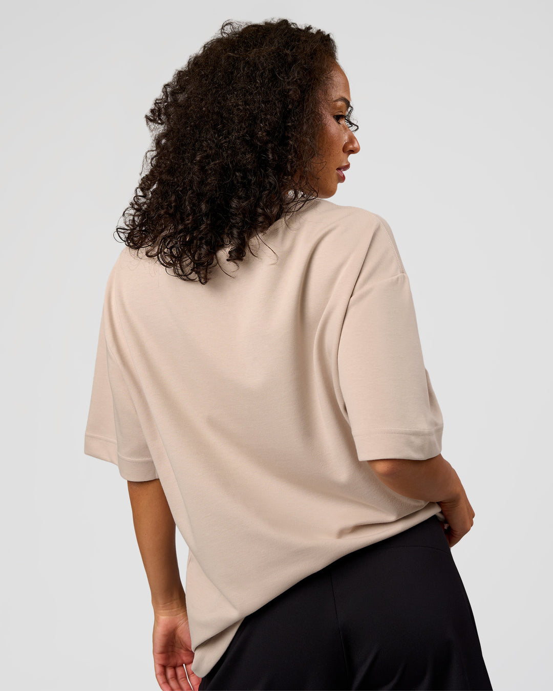 Woman wearing AfterDark ZeroCrease Oversized Tee - Shale Beige | Model:Jasmine | Size:XS