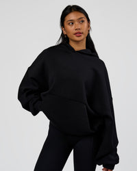 Woman wearing AfterDark ZeroCrease Oversized Hoodie - Black | Model:Loren | Size:XS