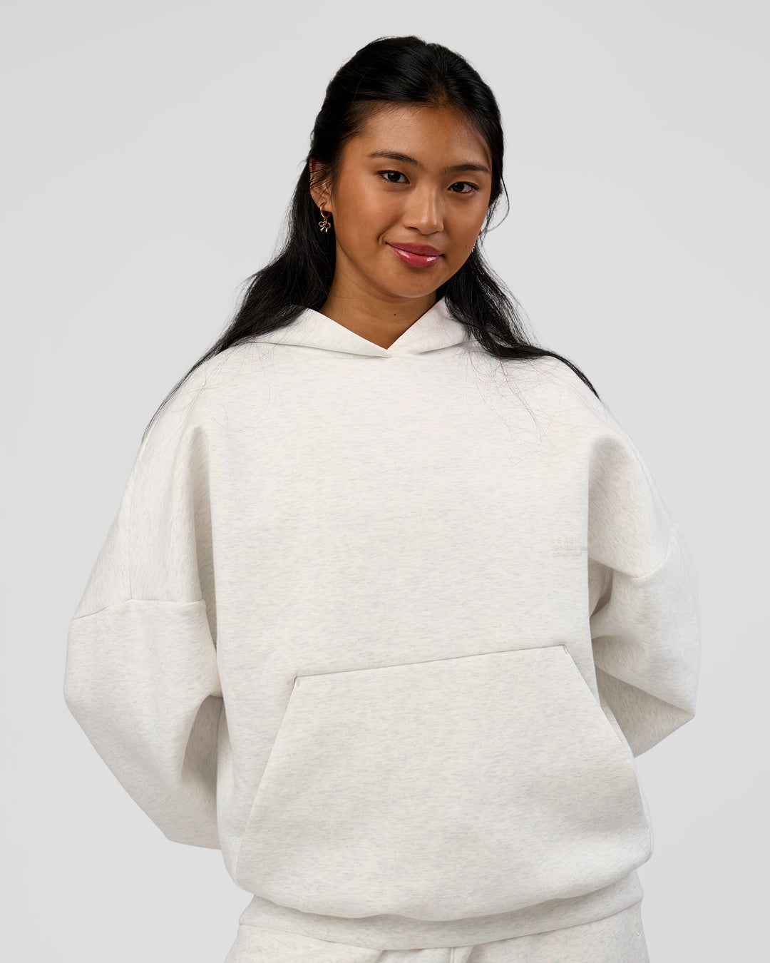 Woman wearing AfterDark ZeroCrease Oversized Hoodie - Silver Marl | Model:Loren |Size:XS