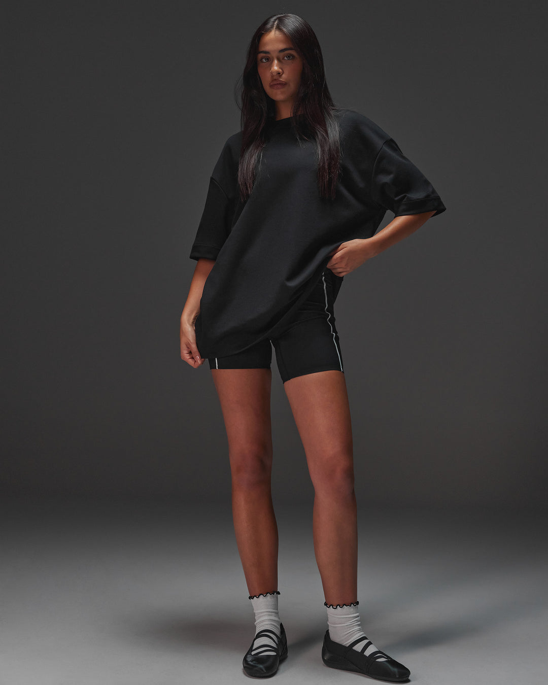 Woman wearing AfterDark ZeroCrease Oversized Tee - Black | Model:Ruby | Size:XS
