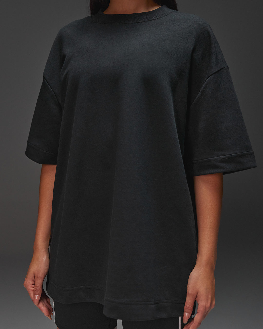 Woman wearing AfterDark ZeroCrease Oversized Tee - Black | Model:Ruby | Size:XS